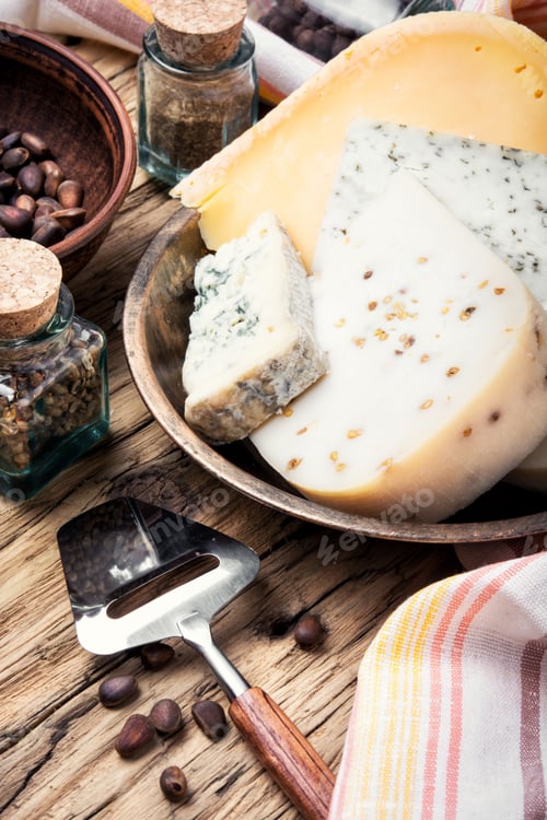 Preview: Different Types Of Swiss Cheese On Rustic Wooden Table
