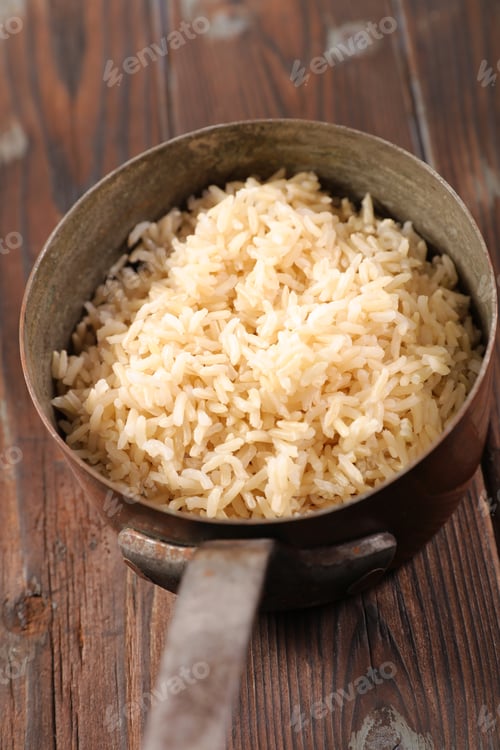 Steaming Bowl of Brown Rice on Wooden Table