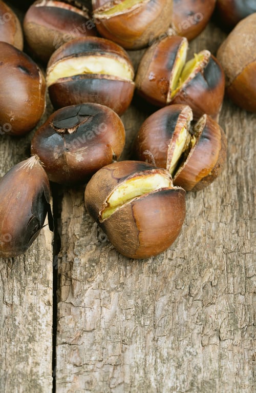 Preview: Roasted Chestnuts On Wooden Surface