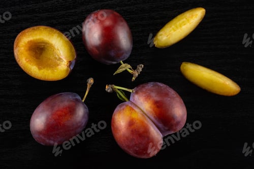 Preview: Fresh Raw Vibrant Plums On Black Wood