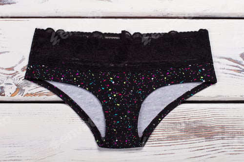 Preview: Black Panties In Multicolored Pattern On Wooden Background. Stylish Women'S Underwear For Every Day.