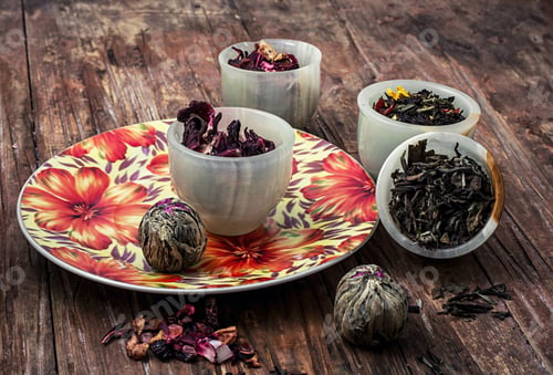Preview: Variety Of Dry Tea Leaves In Jade Stacks On Wooden Background.Toned Image
