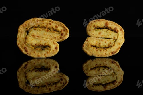 Preview: Group Of Two Whole Baked Savory Cheese Palmier Isolated On Black Glass