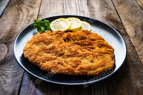 Preview: Schnitzel With Lemon On Wooden Background