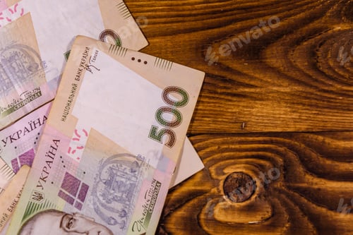 Preview: Ukrainian Five Hundred Hryvnas Banknotes On Rustic Wooden Table. Top View