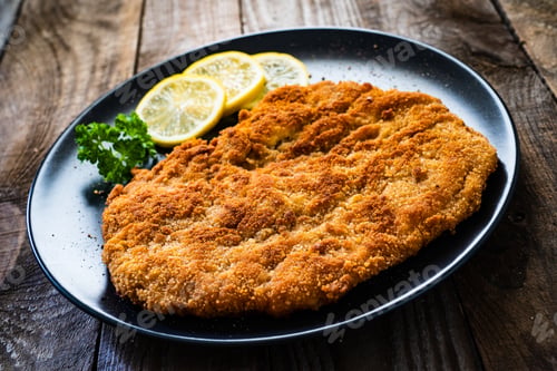 Preview: Schnitzel With Lemon On Wooden Background