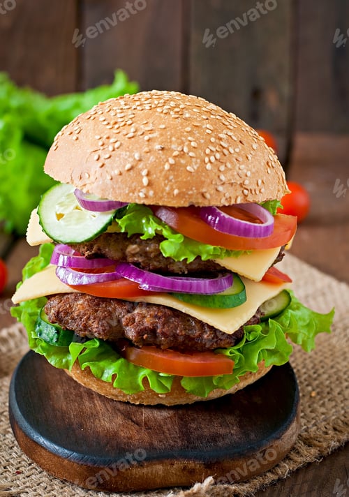Preview: Big Juicy Hamburger With Vegetables And Beef On A Wooden Background In Rustic Style