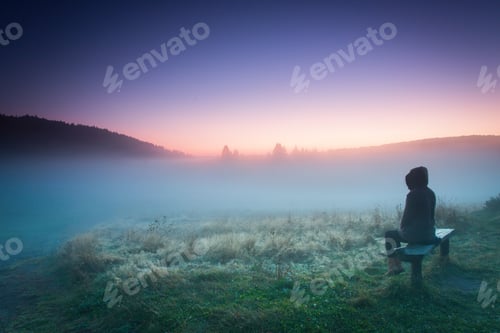 Preview: Woman Relaxing On A Bench In A Foggy Morning