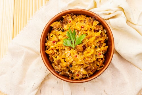 Preview: Stewed (Braised) Cabbage Served On Ethnic Ceramic Bowl. Traditional Polish Bigos With Meat