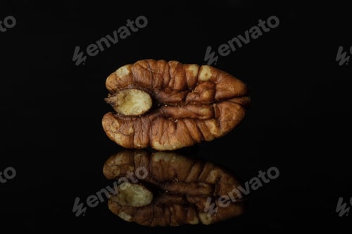 Preview: One Whole Fresh Brown Pecan Nut Half Isolated On Black Glass