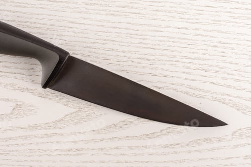 Preview: One Whole Kitchen Tool Stainless Steel Chef Knife With Grey Plastic Handle Flatlay On Grey Wood
