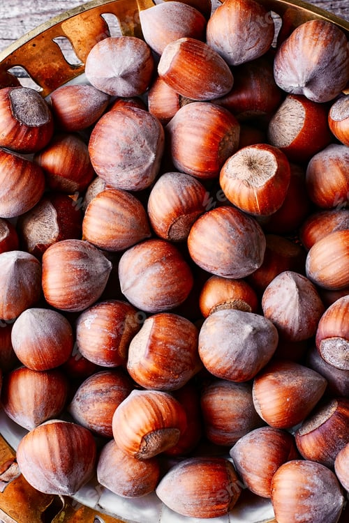 Preview: Fruits Of Hazelnut In The Copper Bowl And Scattered Near.Top View