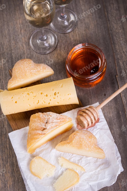 Preview: White Wine In Glasses And Several Types Of Cheese On Wooden Plate