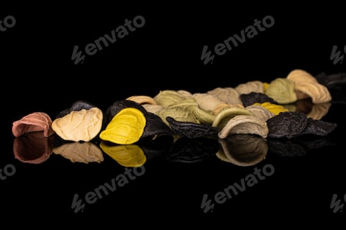 Preview: Lot Of Whole Colored Colorful Pasta Orecchiette Isolated On Black Glass