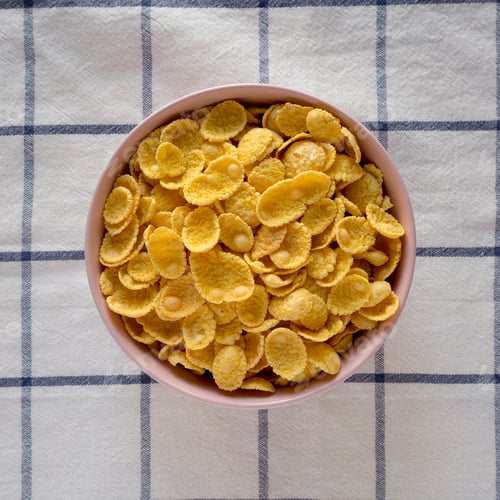 Preview: Corn Flakes In A Pink Bowl For Breakfast On Cloth, Top View. Flat Lay, Overhead, From Above.