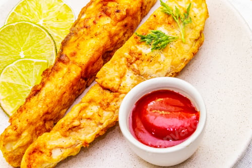 Preview: Grilled (Fried) Pollock In Batter. On Ceramic Plate With Lime, Parsley And Sauce. Cooking Fresh