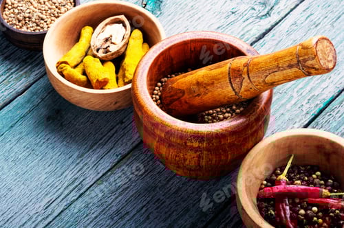 Preview: Spices in wooden bowls with mortar and pestle