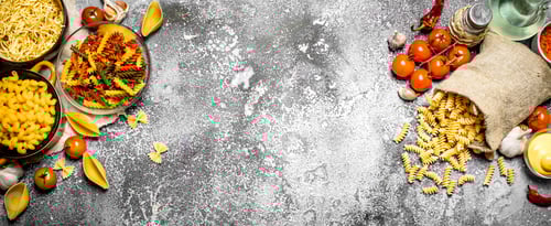 Preview: Pasta Background. Pasta With Sauces, Vegetables And Olive Oil.On Rustic Background.