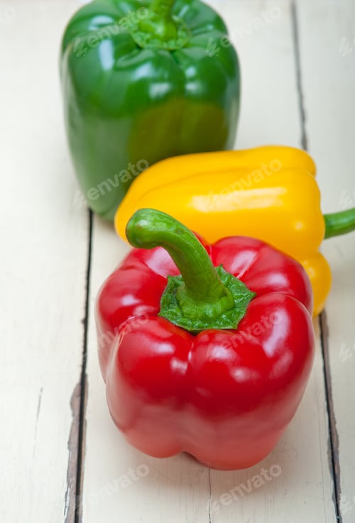Preview: Three Fresh Bell Peppers Over Old Wood Table
