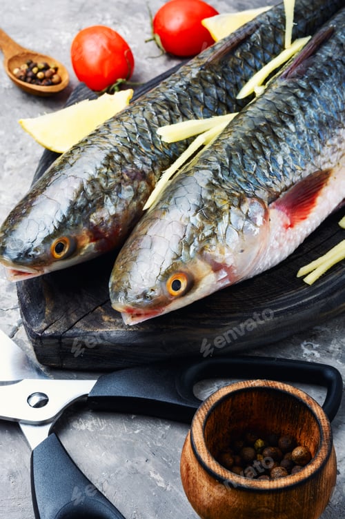 Preview: Fresh Raw Sea Fish On Wooden Cutting Board
