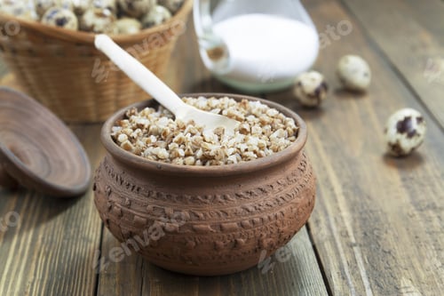 Preview: Buckwheat Porridge,Milk And Quail Eggs In The Pot On The Table