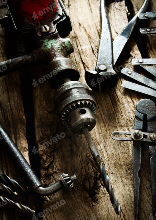 Preview: The Old Working Tool. Old Drill, Compasses, Pliers And Drills On A Wooden Background.