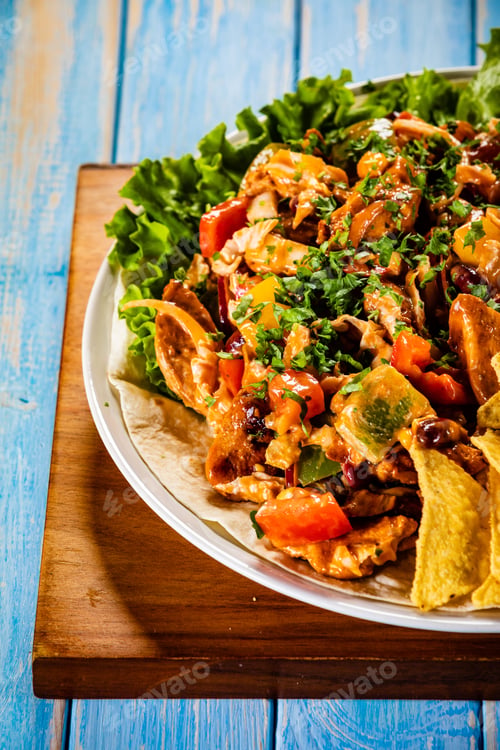 Preview: Grilled Chicken Meat With Nachos And Vegetables On Wooden Background