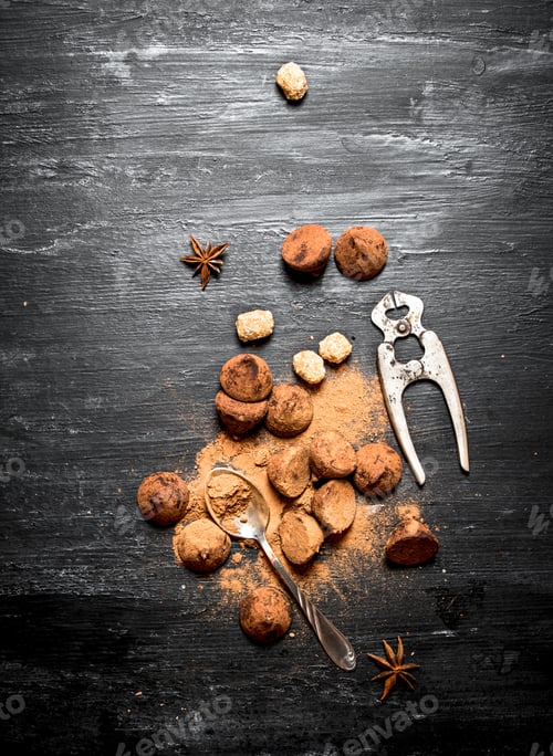 Preview: Chocolate Truffles With Cocoa And Cinnamon. On A Black Wooden Background.