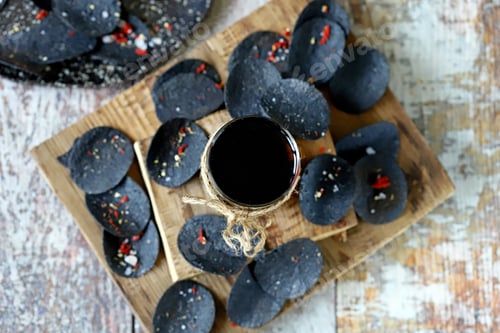 Preview: Selective Focus. Black Soda Glass And Black Chips. Original Snack. Black Minimalistic Food Trend.