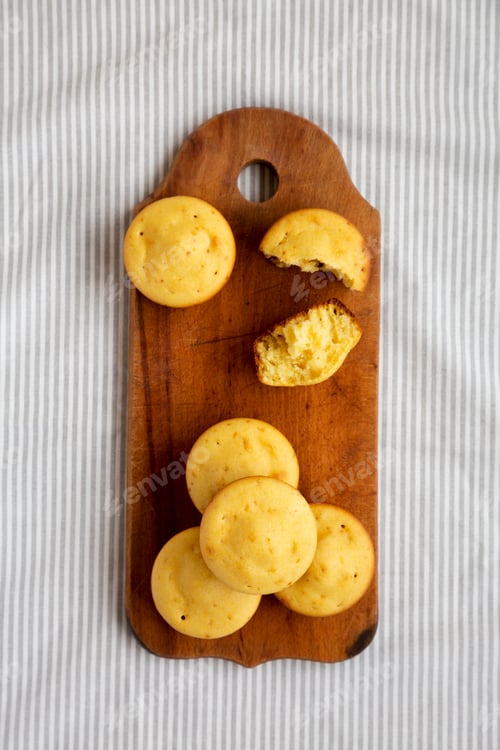 Preview: Homemade Cornbread Muffins On A Rustic Wooden Board, Overhead View. Flat Lay, From Above, Top View.