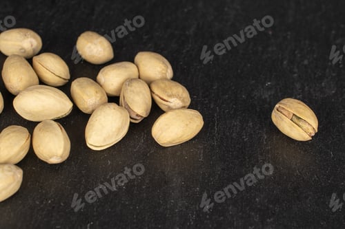 Preview: Lot Of Whole Salted Pistachio On Grey Stone