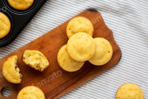 Preview: Homemade Cornbread Muffins On A Rustic Wooden Board, Top View. Flat Lay, From Above, Overhead.