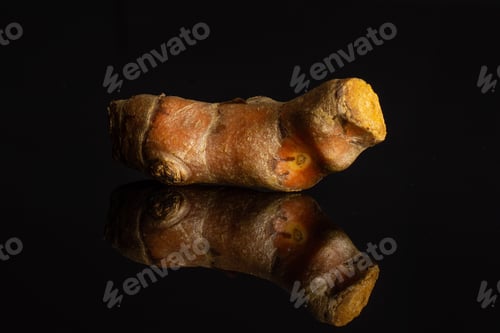 Preview: One Whole Ripe Bright Turmeric Rhizome Isolated On Black Glass