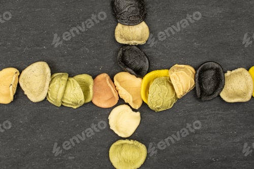 Preview: Lot Of Whole Colorful Pasta Orecchiette Crossed Flatlay On Grey Stone