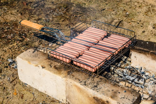 Preview: Sausages Cooking In Barbecue Grill On Campfire