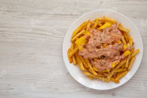 Preview: Homemade Animal Style French Fries On A White Plate On A White Wooden Table, Top View. Flat Lay
