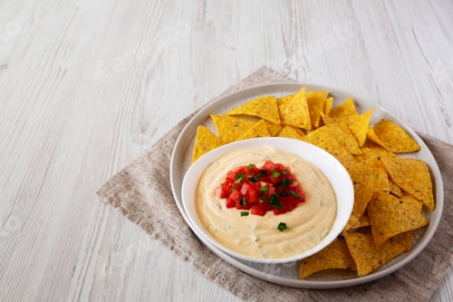 Preview: Homemade Cheesy Dip In A Bowl, Yellow Tortilla Chips, Side View. Space For Text.