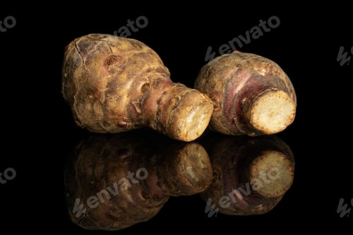 Preview: Group Of Two Whole Fresh Brown Jerusalem Artichoke Isolated On Black Glass