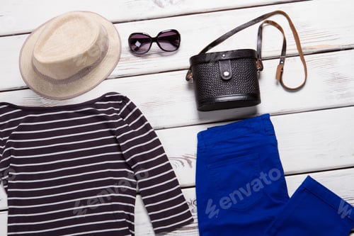 Preview: Beige Hat And Black Purse. Navy Pants And Sunglasses. Female Accessories On White Shelf. Set Of