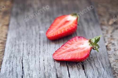 Preview: Ripe Strawberry Is Bisected, On A Wooden Background
