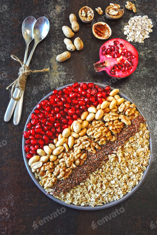 Preview: Vegan Bowl Of Oatmeal, Nuts, Flax Seeds And Pomegranate. Healthy Breakfast Or Snack. Keto Breakfast