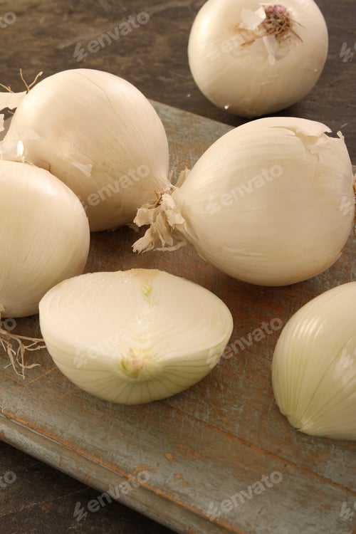 Fresh White Onions on Wooden Cutting Board