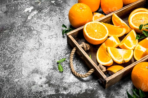 Preview: Fresh Slices Of Oranges In A Wooden Tray. On A Rustic Background.