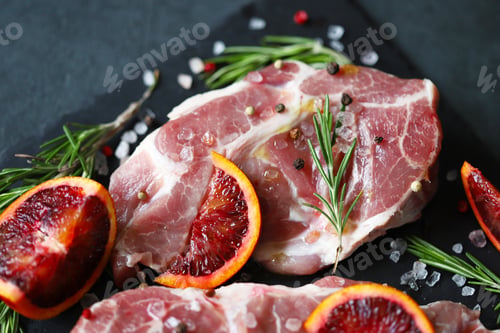 Preview: Raw Meat Steaks With Rosemary And Spices On A Stone Board. Keto. Paleo. Pegan Diet.