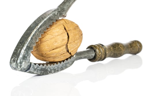 Preview: One Whole Tasty Brown Walnut With Wooden Nutcracker Isolated On White Background