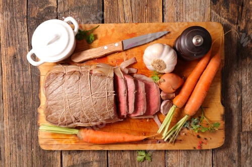 Preview: Roast Beef With Carrot And Sauce On Wooden Board