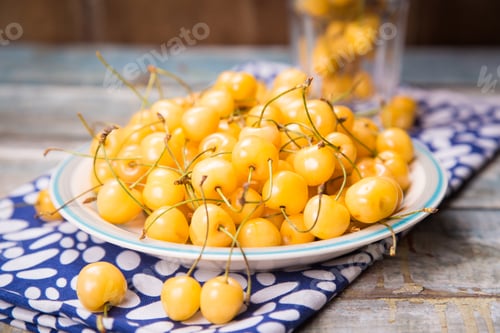 Preview: Fresh Ripe Raw Yellow Sweet Cherry On Colored Plate