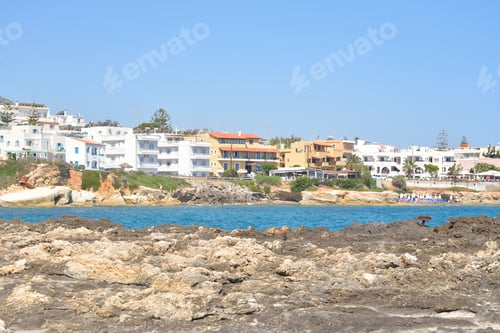 Preview: Rocks On The Shore Of The Sea And The City Of Hersonissos, Crete, Greece.