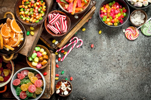Preview: Various Sweets And Candied Fruits. On A Rustic Background.