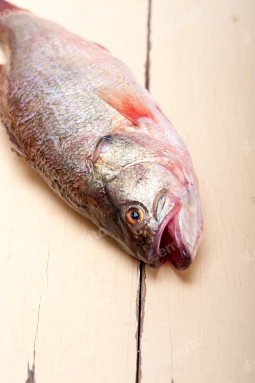 Preview: Fresh Whole Raw Fish On A Wooden Table Ready To Cook